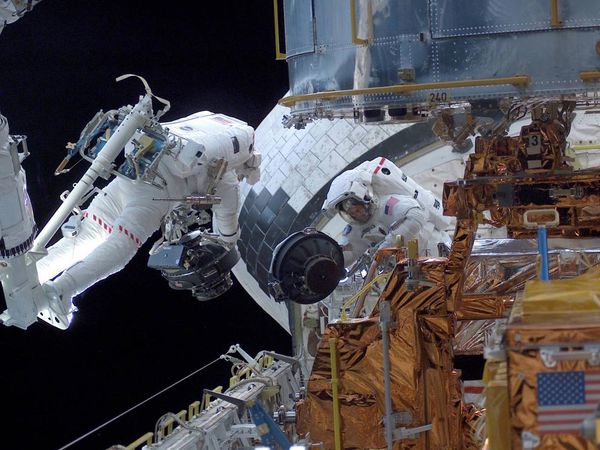 Astronouts Servicing The Hubble Space Telescope